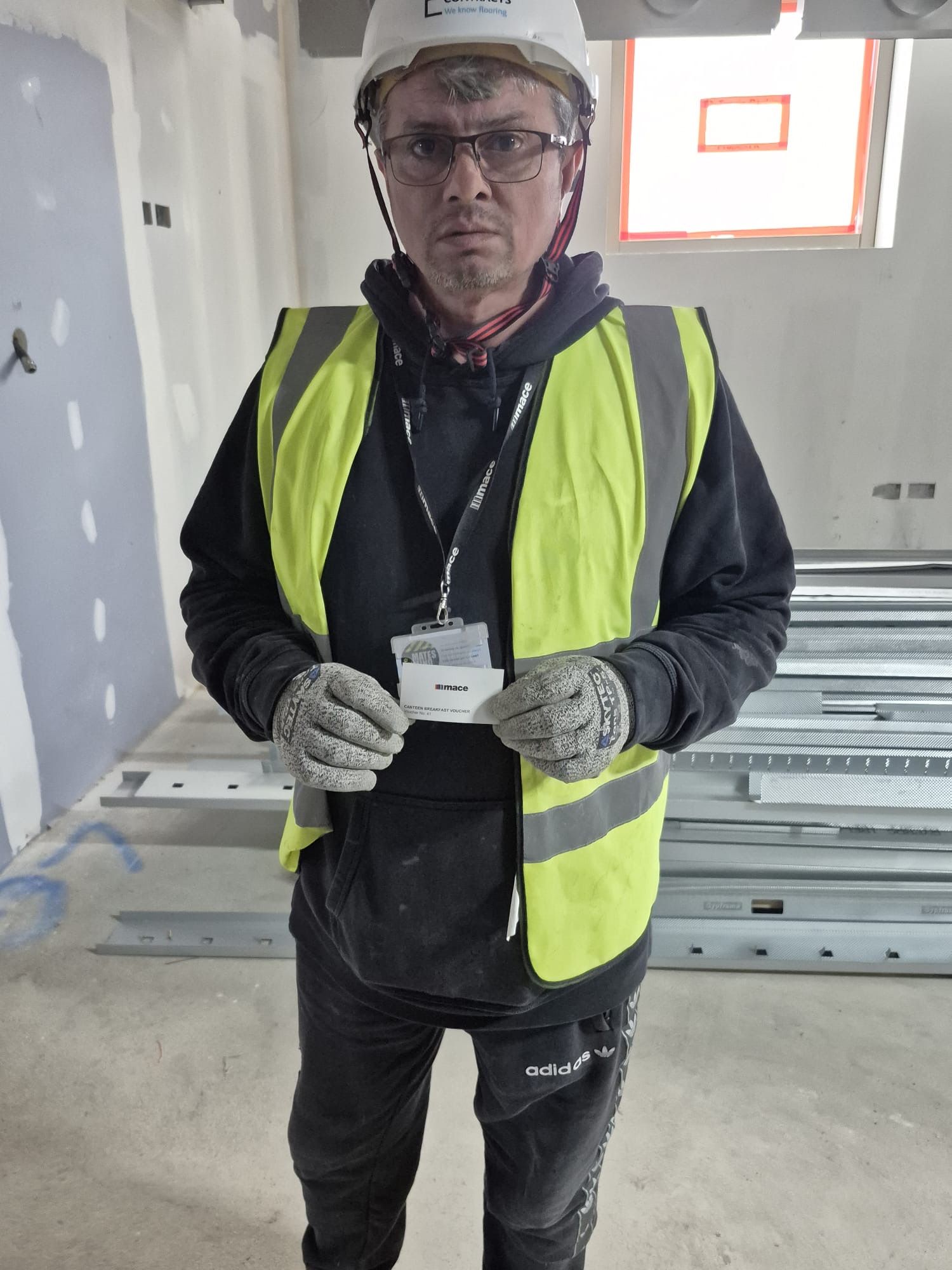 Team member receiving Green Card for UCL ION - Loughton Contracts