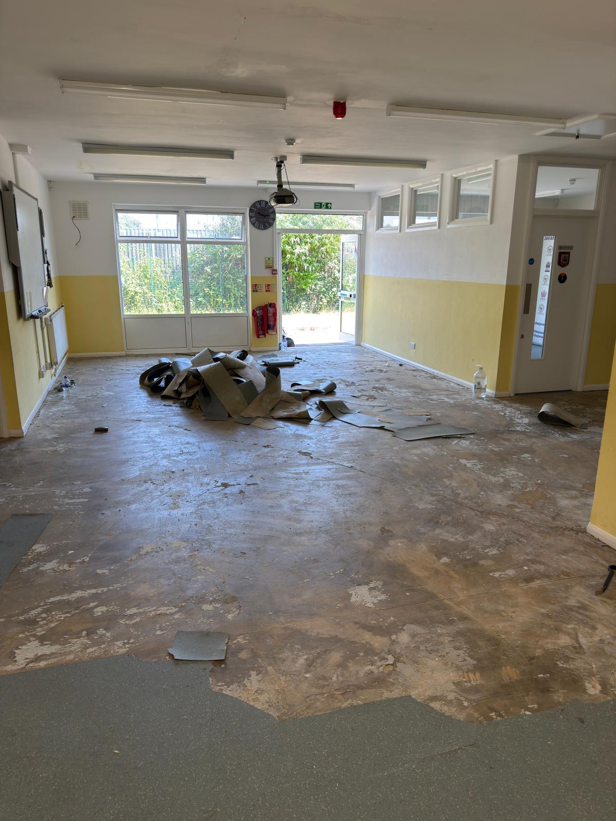 Removal of the old vinyl flooring in preparation of new installation by Loughton Contracts