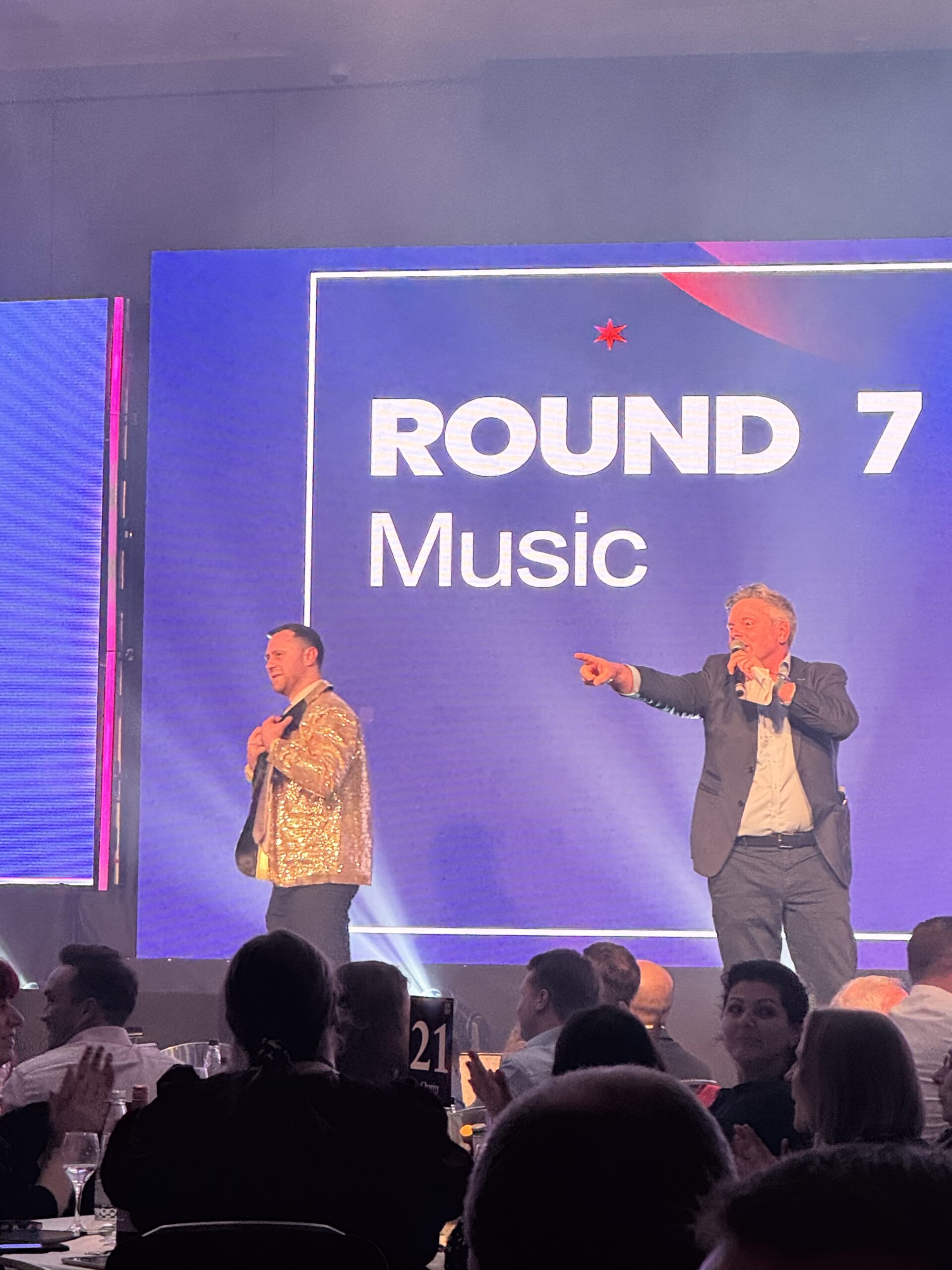 Tom Osmond on stage at the Overbury Charity Quiz Night 2026